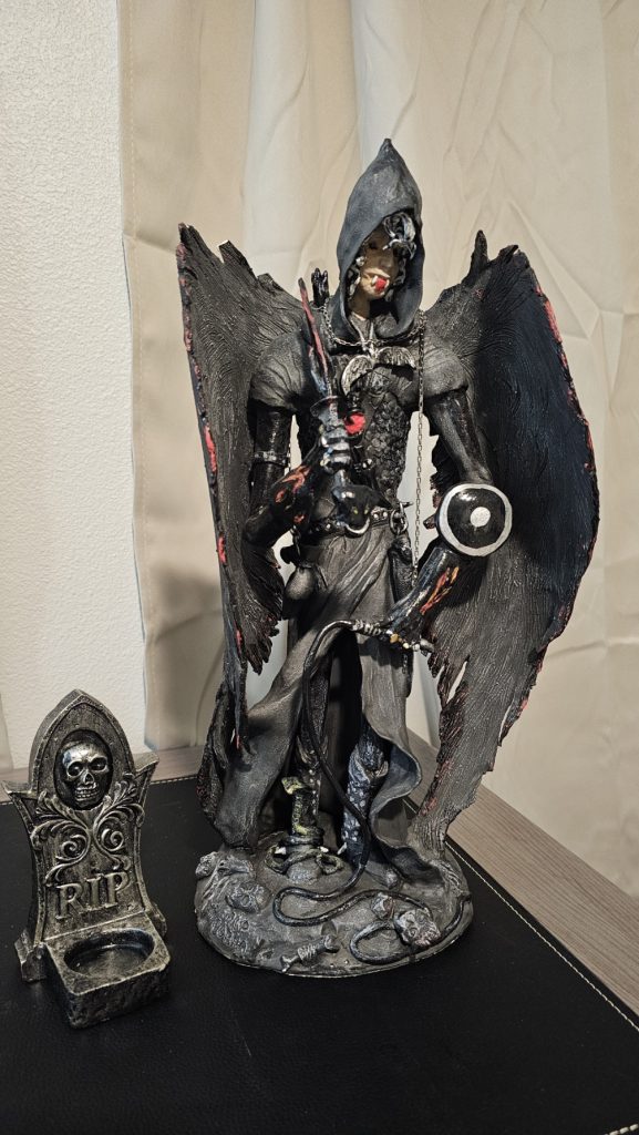 Large 18-inch tall hand-sculpted clay figure of a dark winged hooded warrior with detailed armor and weapons. A small RIP tombstone sits beside it. Part of Nathan’s personal collection.
