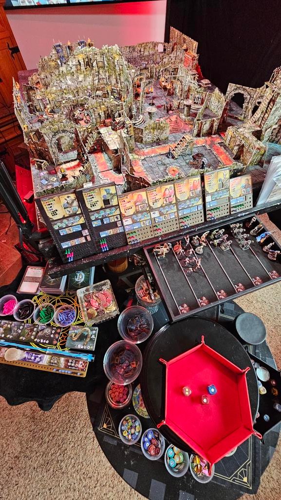 Large detailed Maladum / Battle Systems gaming table setup with extensive painted terrain, ruins, miniatures, character sheets, and gaming accessories on a custom 4x3 table.